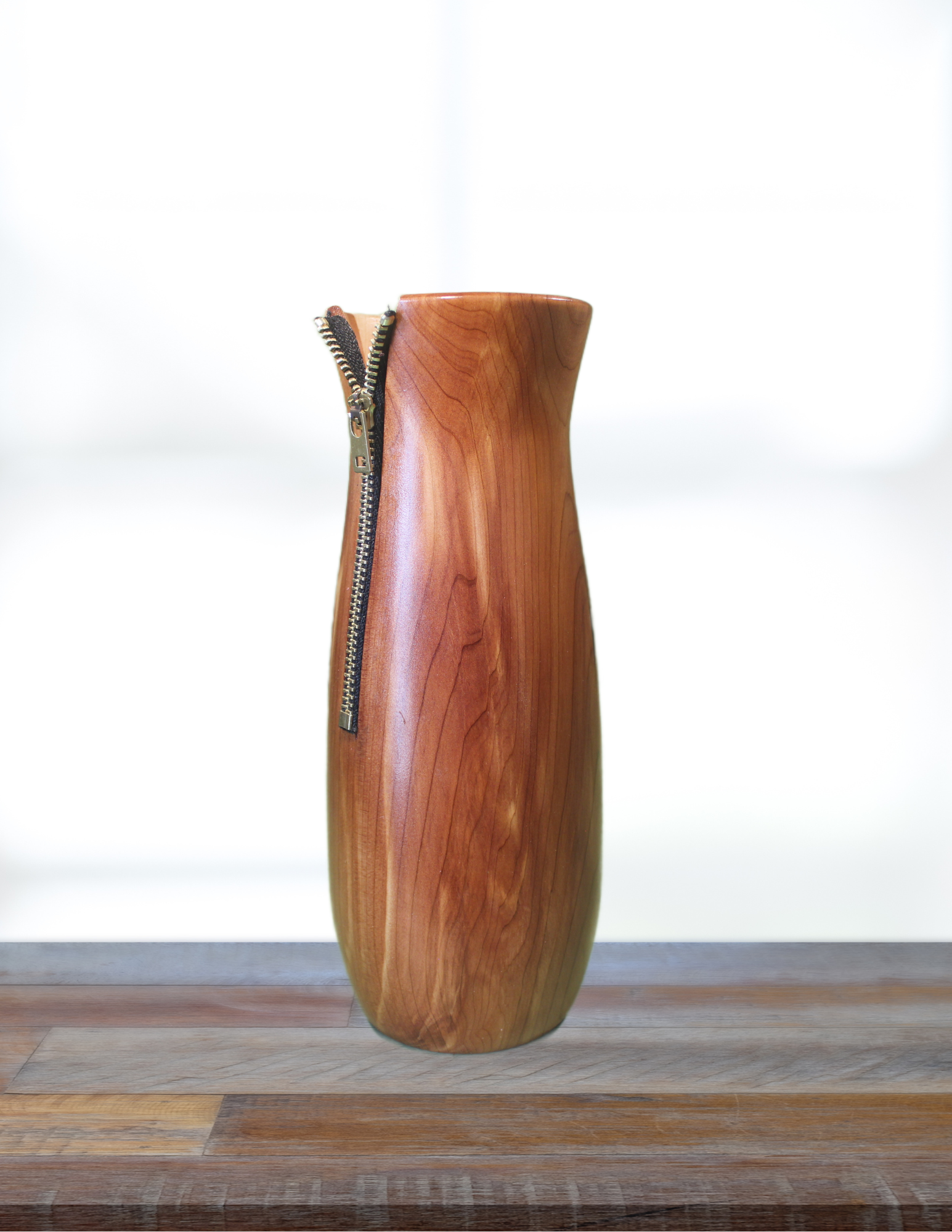 Wooden vase with a zipper on a wooden surface