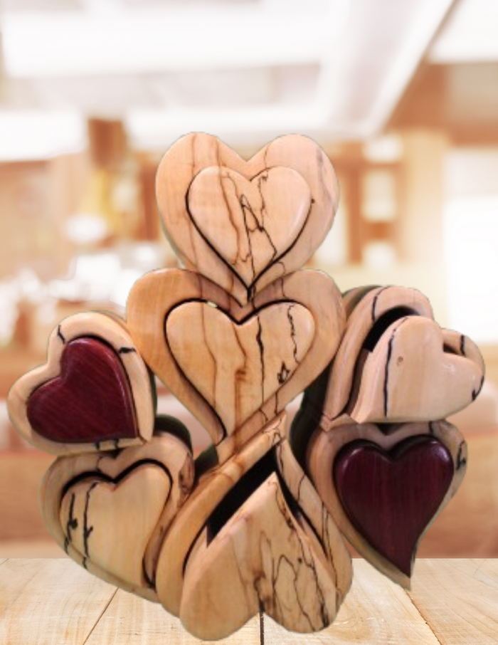 Wooden heart-shaped object with maroon centers on a nice background. Good for jewelry and other wearing pieces. 