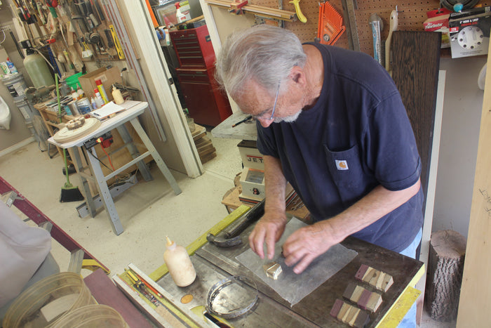 Thom-Pabst-Working-on-creating-a-custom-piece-for-friends-while-in-a-workship-wearing-a-blue-shirt