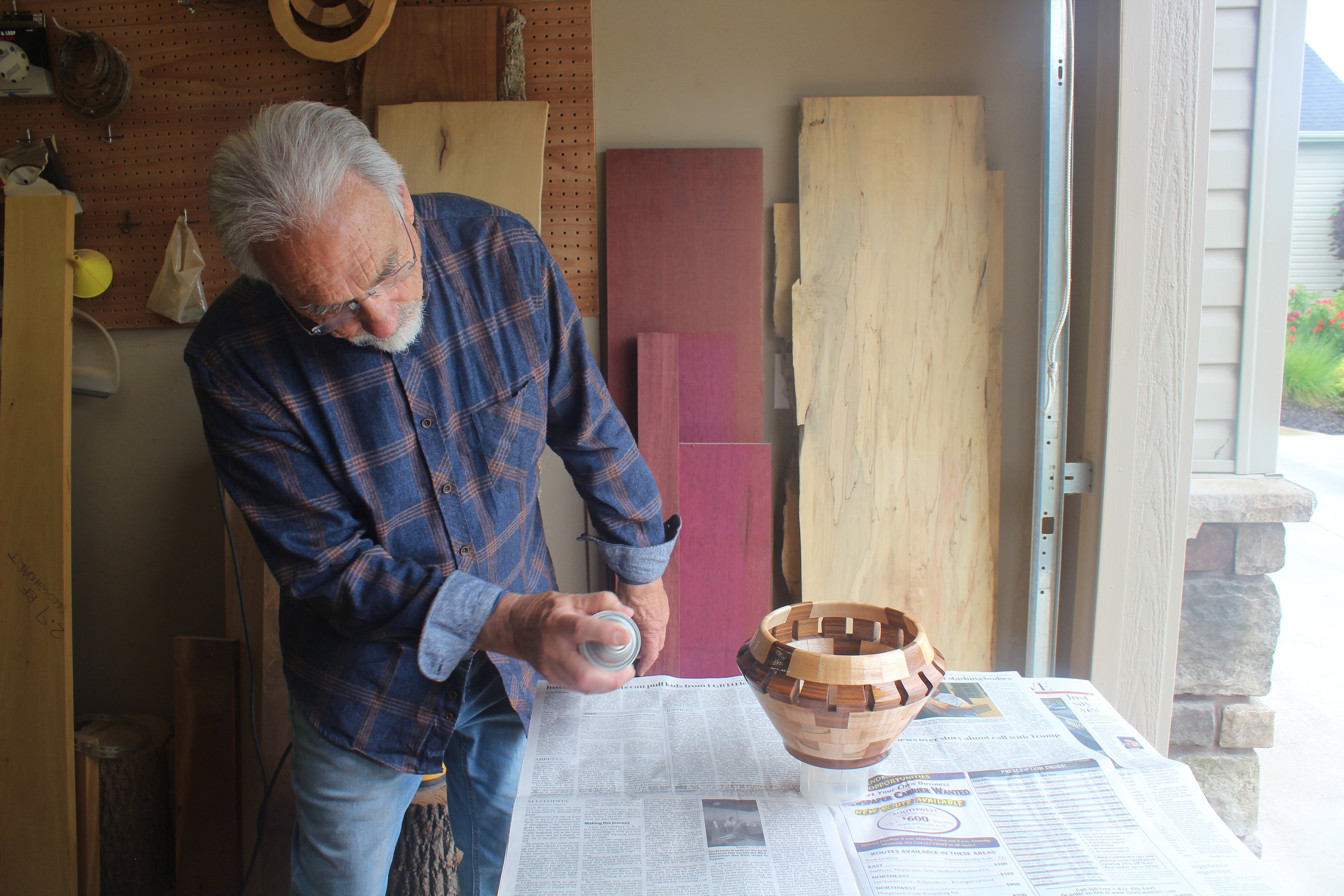 Man working on a wooden bowl in a workshop