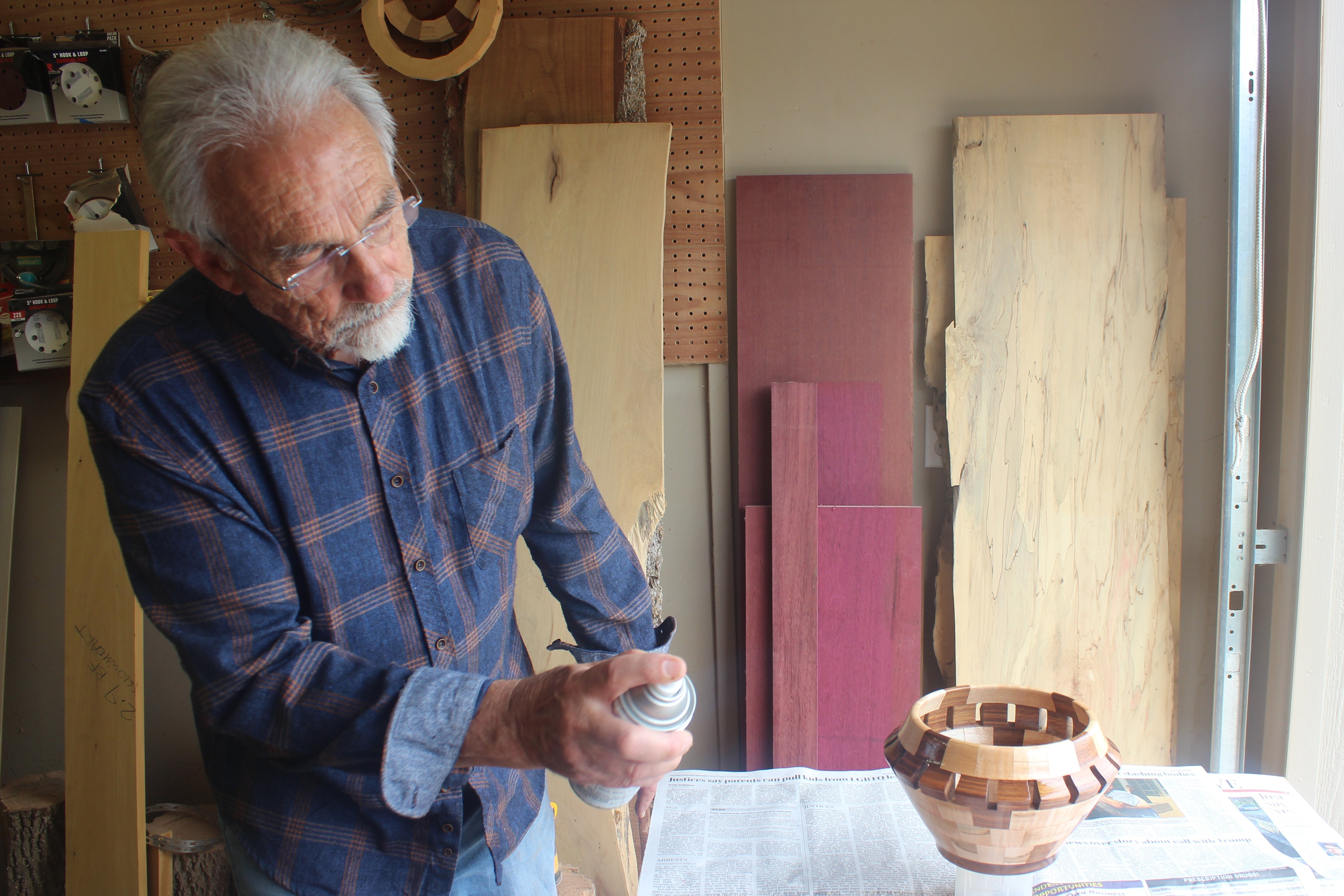 Man working on a wooden bowl in a workshop