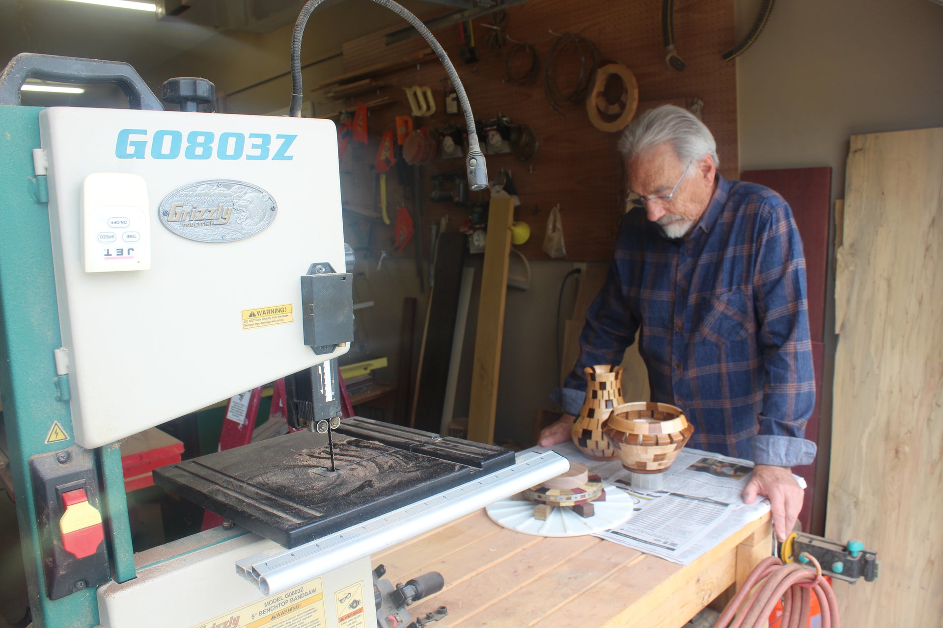 Man working with a bandsaw in a workshop