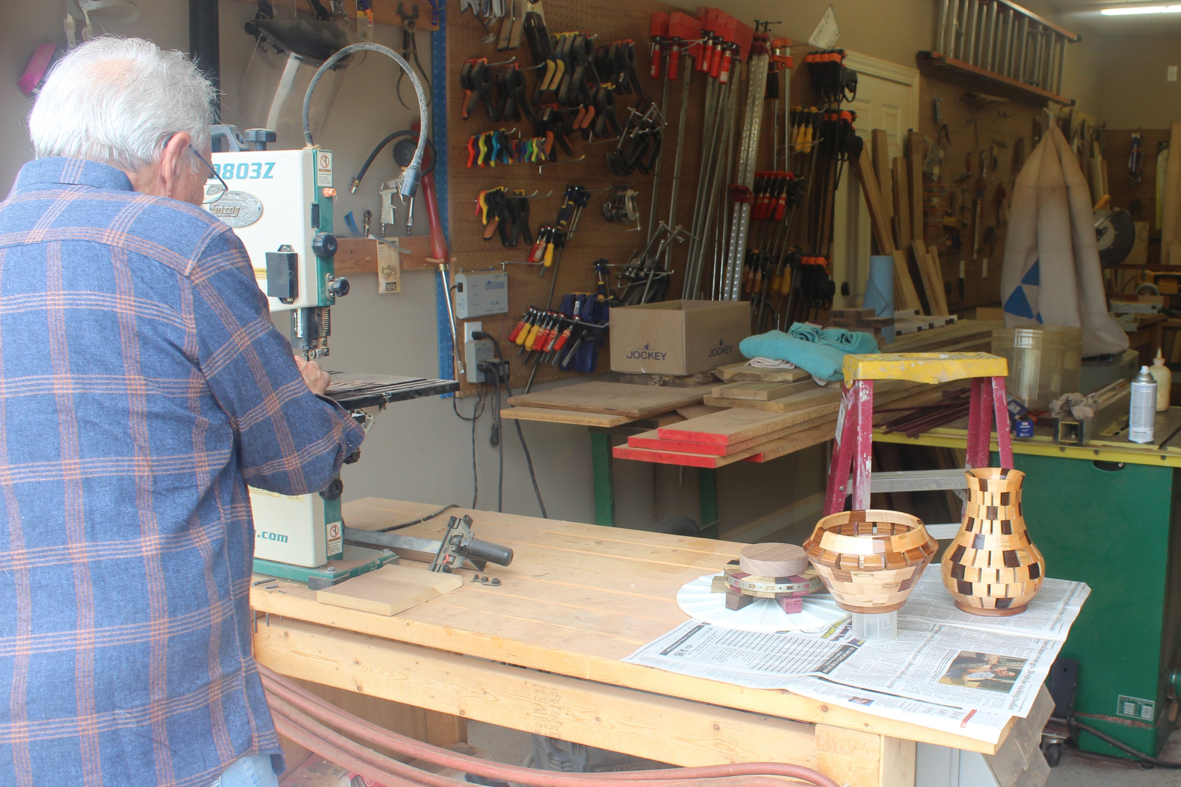 Person working in a workshop with tools and equipment around