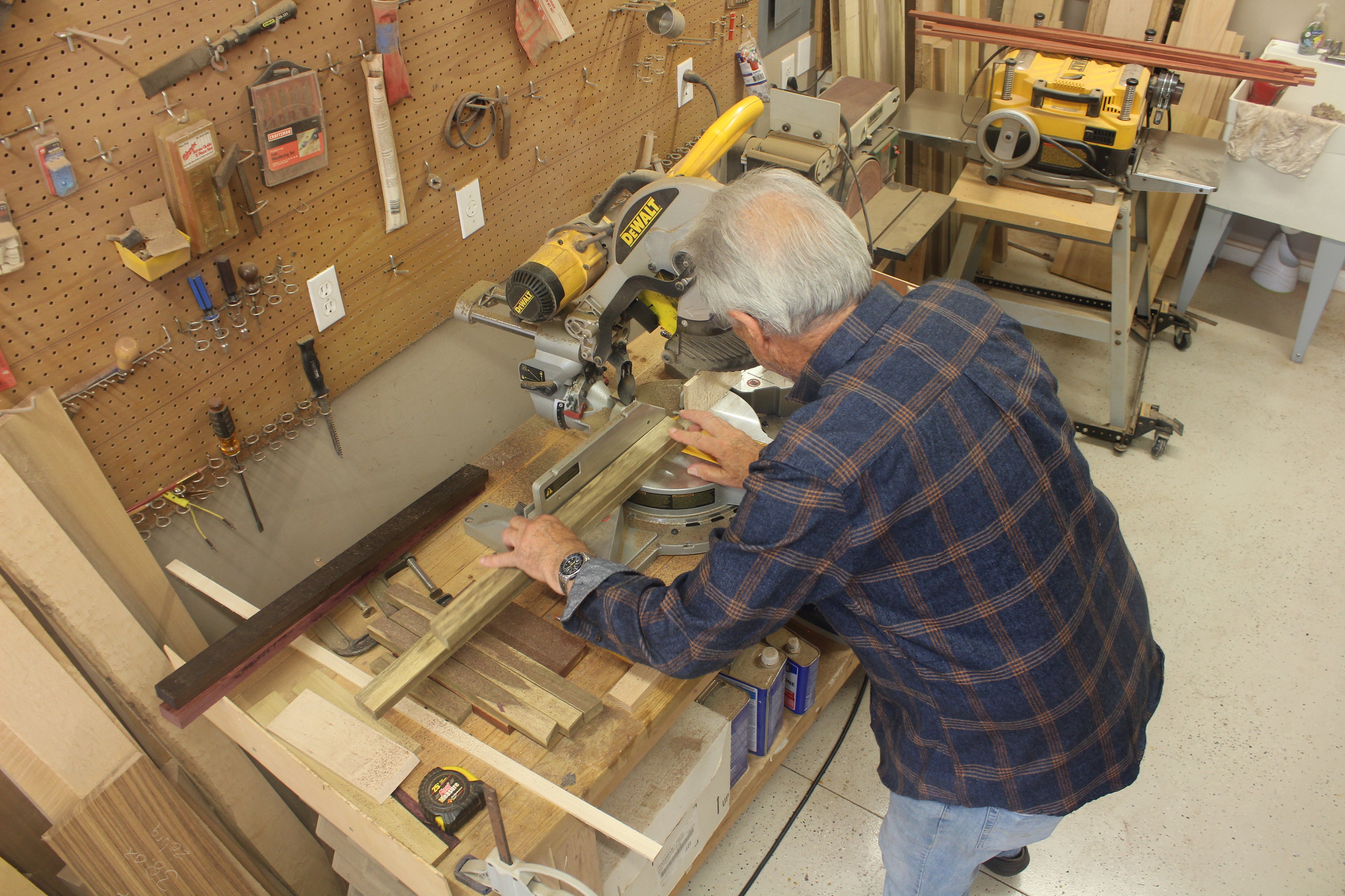 Thom Pabst working with a saw to cut exotic wood